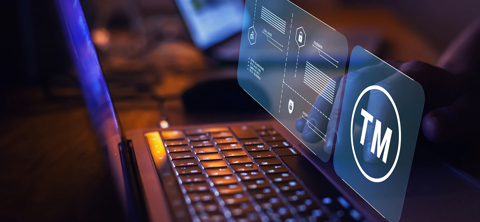Person typing on a laptop with holographic overlays featuring a copyright symbol, scales of justice, and digital security icons